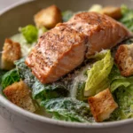 Close-up of air fryer salmon caesar salad with fresh greens and crispy salmon pieces