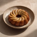 Close-up of a banana cake with a minimalist Korean aesthetic, showcasing its texture and color.
