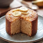 Close-up of a moist banana cake kukus with a golden crust and soft texture.