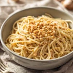 Close-up of creamy one pot pasta with visible textures and bright lighting