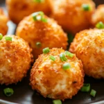 Close-up of crispy air fryer shrimp balls on a white plate with dipping sauce