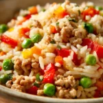 Close-up of a ground turkey and rice dish with vibrant colors and textures.