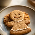 Close-up of delicious oatmeal cookie gingerbread girl with warm lighting and minimal background.