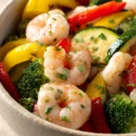 Close-up of shrimp and vegetables cooked in an air fryer, vibrant and appetizing.