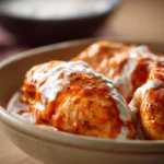 Slow Cooker Buffalo Chicken with Greek Yogurt for Cozy Weeknight Dinners 3 Close-up of slow cooker buffalo chicken with creamy Greek yogurt sauce, garnished with herbs.