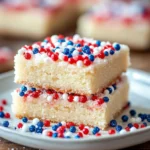 Close-up of sugar cookie bars with red, white, and blue sprinkles for 4th of July celebration.