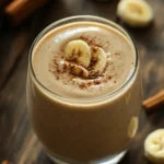 Close-up of a banana bread smoothie in a glass with a clean background
