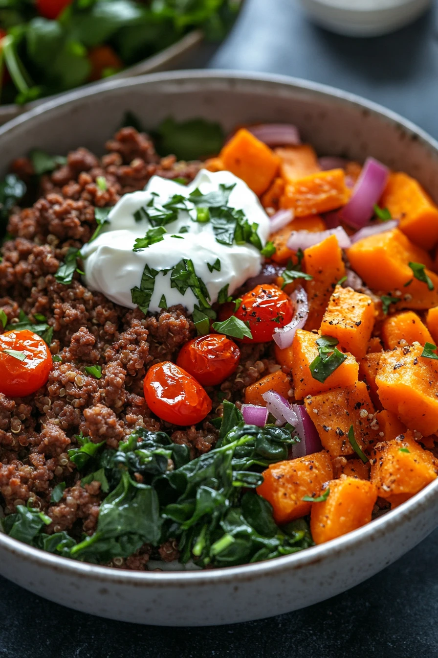 Close-up of a high protein beef and sweet potato bowl with vibrant colors and fresh ingredients.