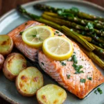 When You Need a Cozy Oven Baked Salmon Dinner for Two 3 Oven baked salmon dinner with lemon slices and herbs on a white plate