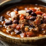Close-up of a hearty slow cooker stew meat chili with beans and spices.